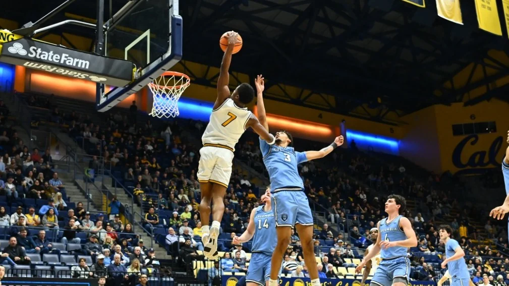 California men's basketball player reaching for the rim during a home game at Haas Pavilion