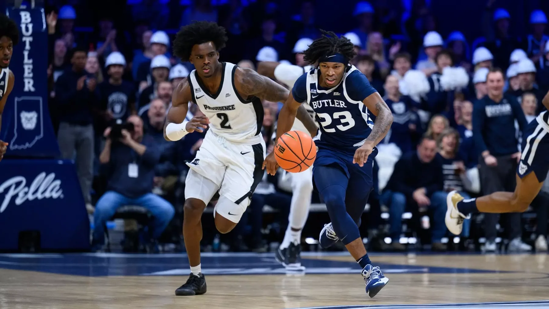 Butler ball handler dribbles beside a Providence defender in a college basketball game