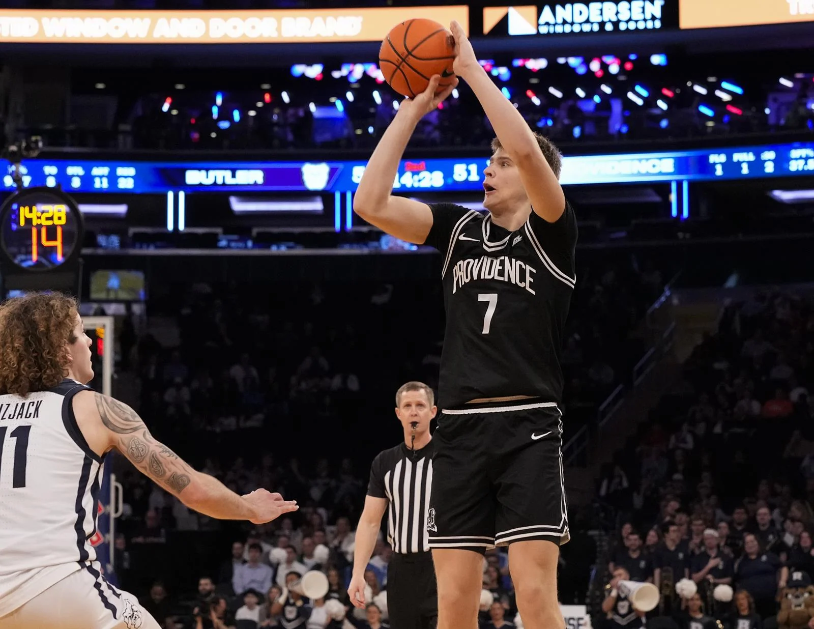 Providence player shoots over a Butler defender in a BIG EAST Tournament game