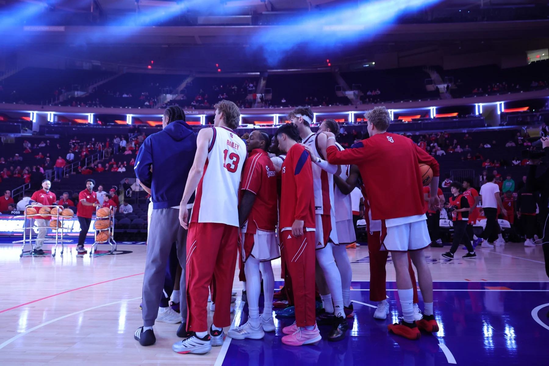 St. John's players huddle on the Madison Square Garden court before a game