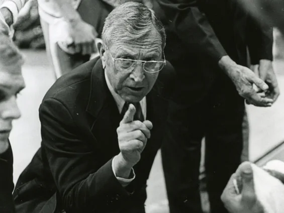 John Wooden instructing UCLA basketball players on the court