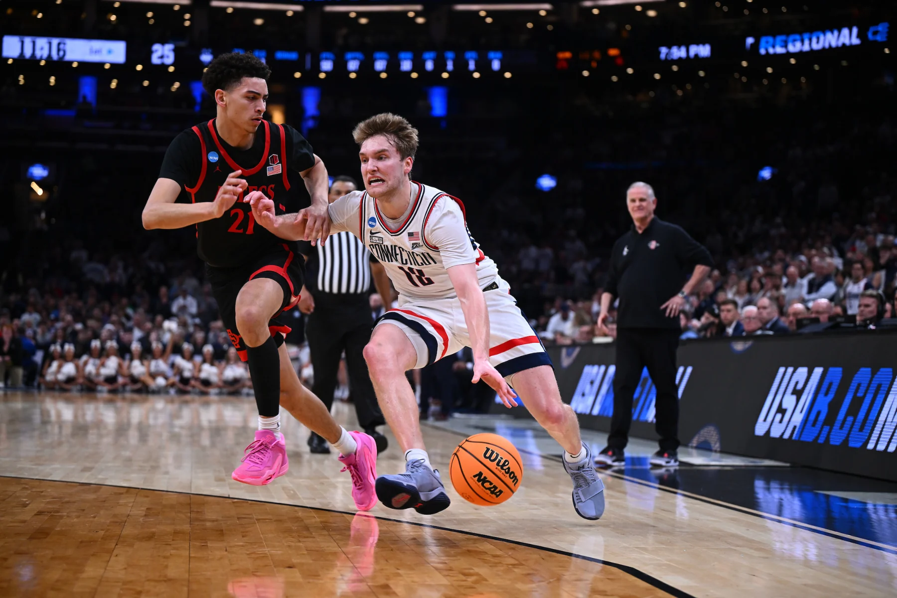 Cam Spencer drives with the ball beside a San Diego State defender