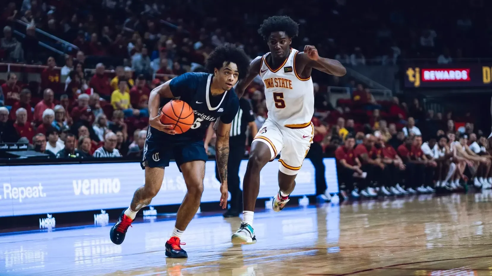 Creighton ballhandler driving past an Iowa State defender
