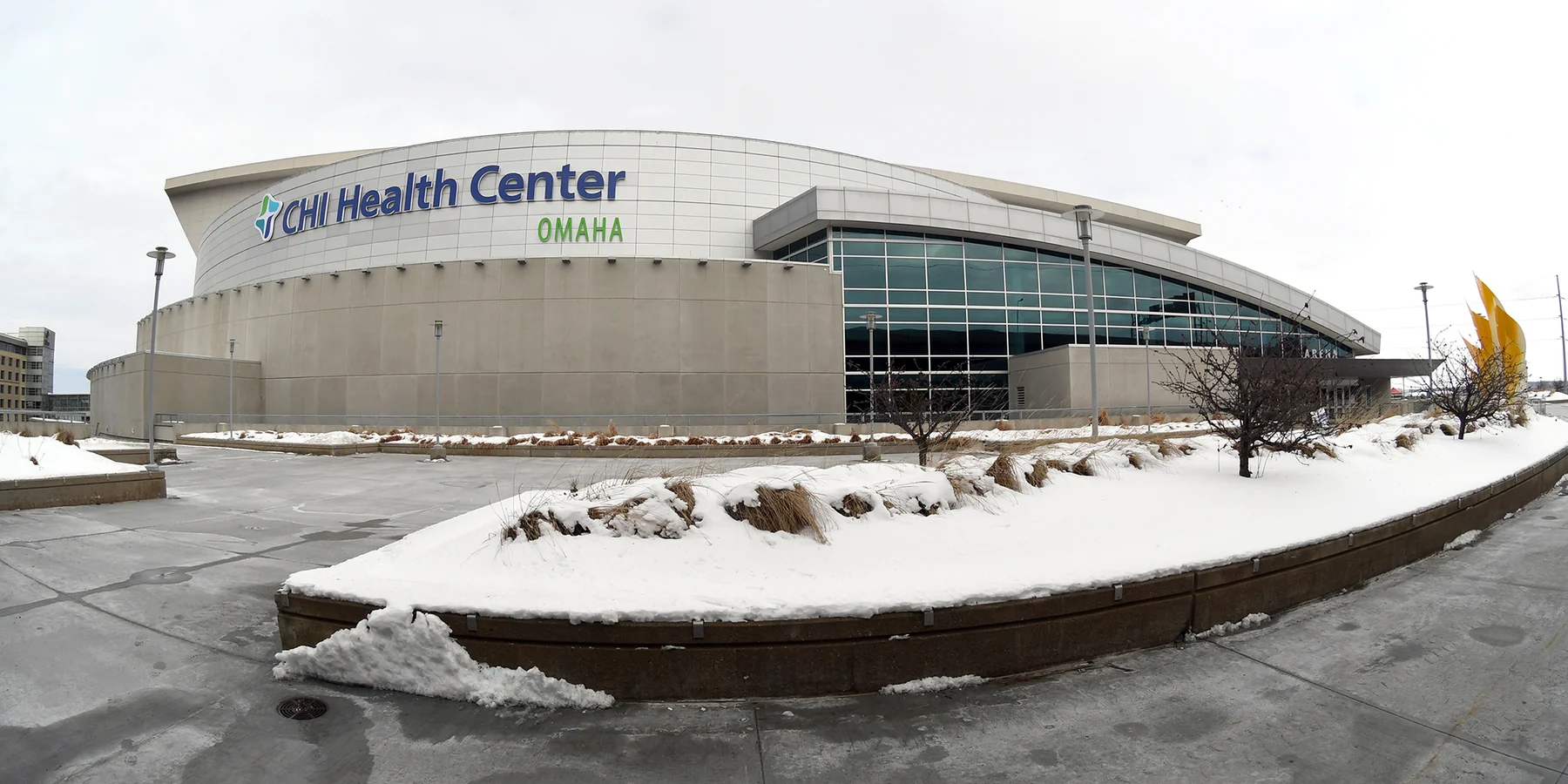 Exterior of CHI Health Center Omaha with snow beside the walkway