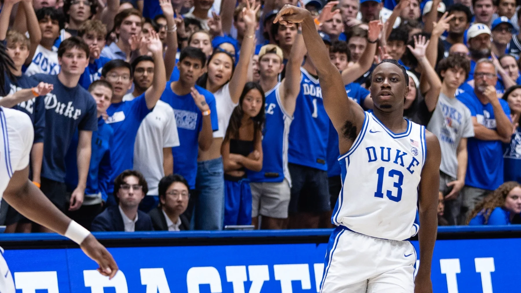 John Blackwell follows through on a shot in white Duke number thirteen before the Cameron crowd