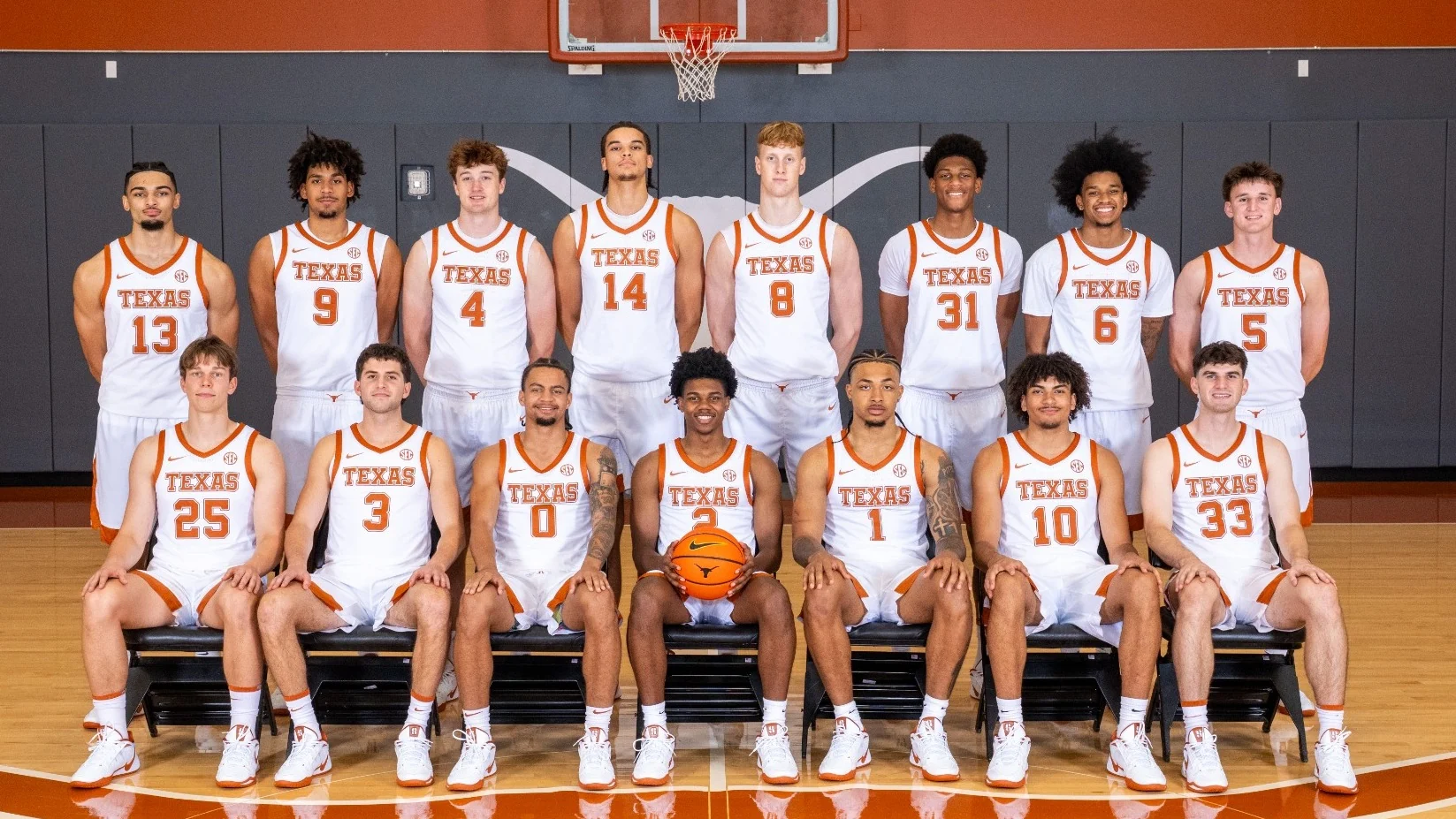 Texas basketball players arranged in two rows on a practice court