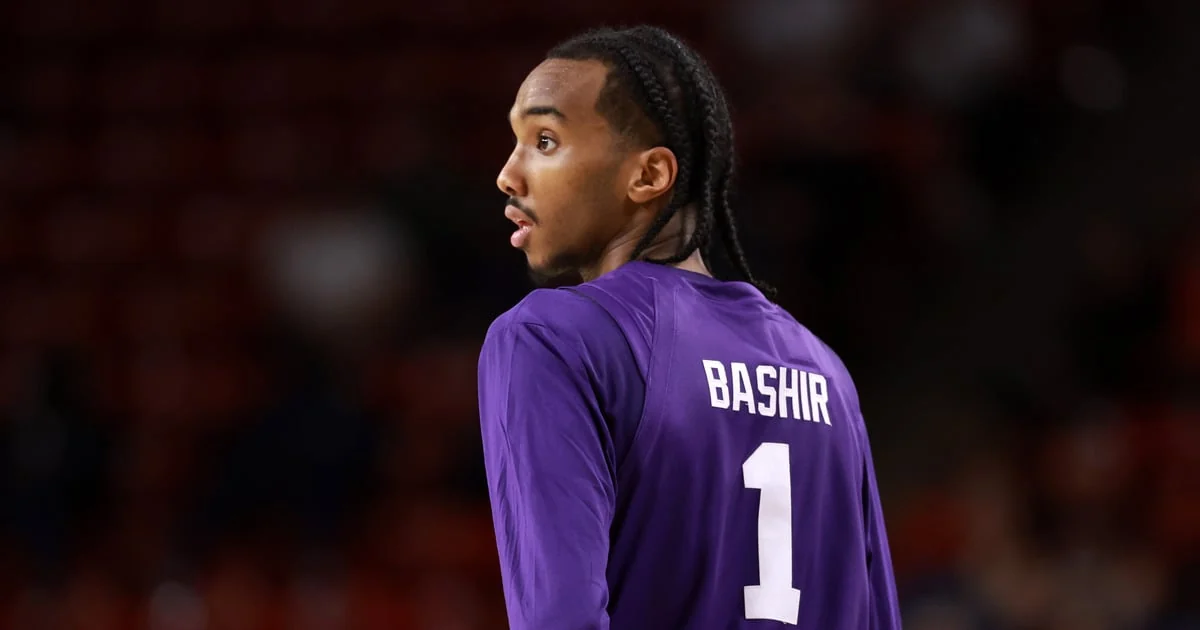 Abdi Bashir Jr. wearing a purple number1 Kansas State warmup shirt