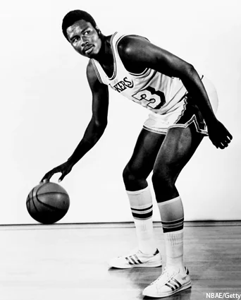 Travis Grant dribbles a basketball in a historical Lakers number 33 uniform