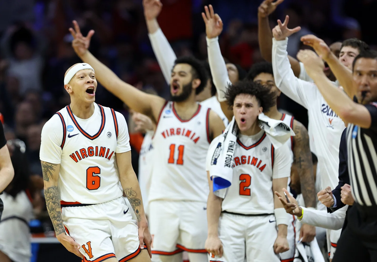 Virginia players celebrate beside the court during the 2026 NCAA tournament first round