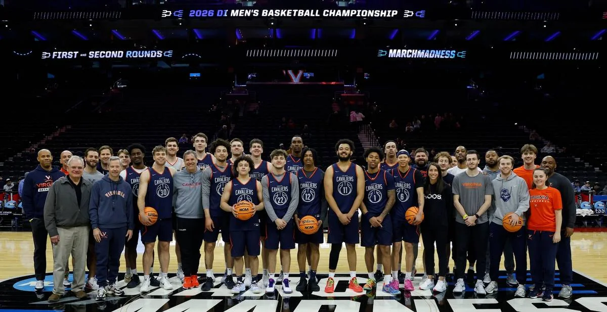 Virginia players and staff pose on an NCAA first- and second-round court in Philadelphia