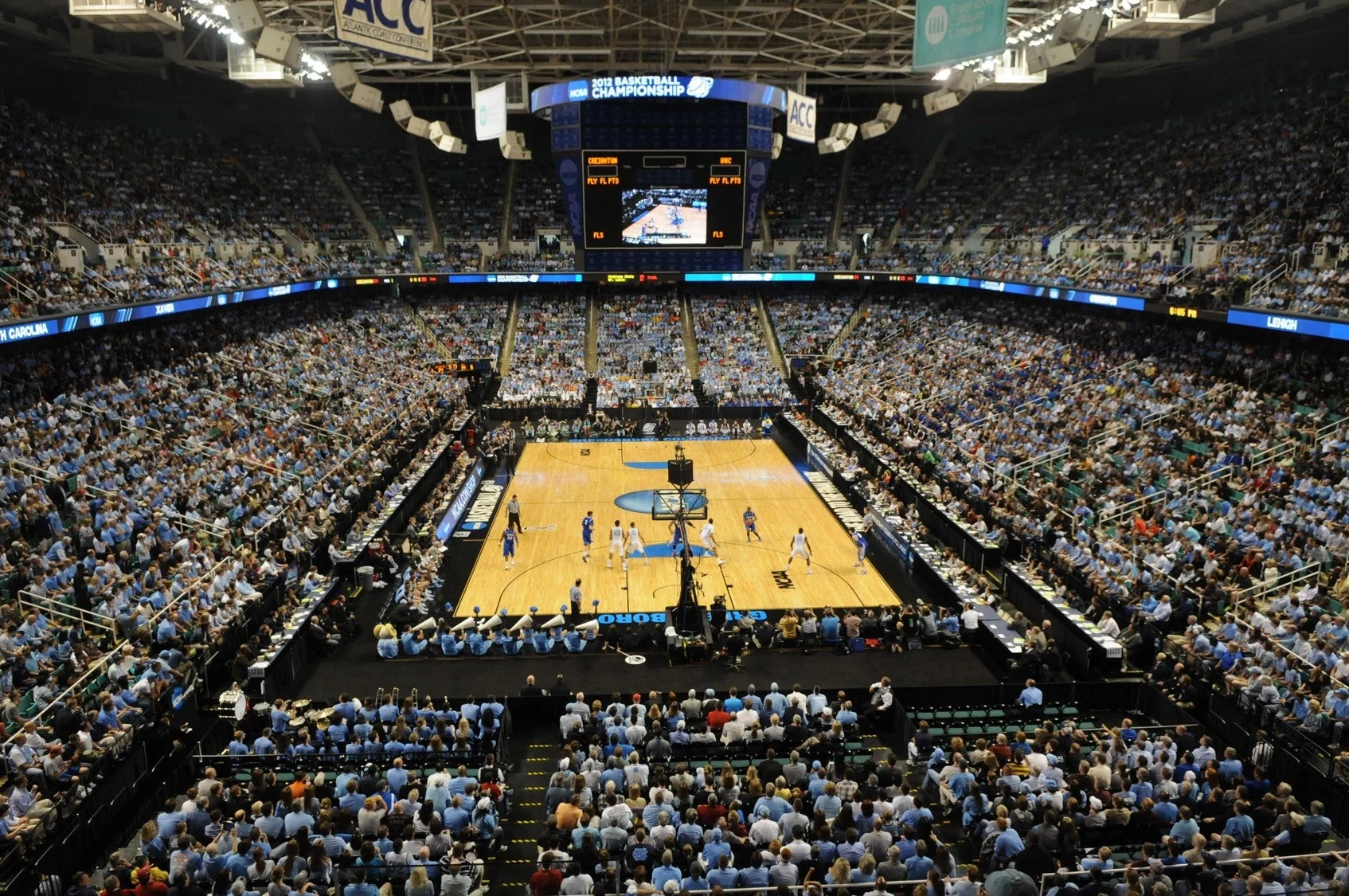 A college basketball game viewed across a full arena seating bowl