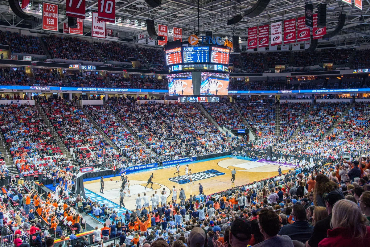 An elevated sideline view of a college basketball court and surrounding seats