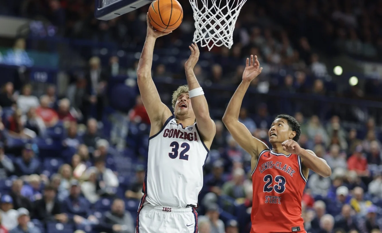 Gonzaga number thirty-two attempting a layup against a Lewis-Clark State defender in red