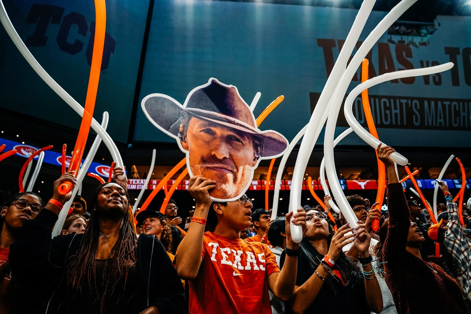 Texas supporters waving orange and white balloons inside Moody Center