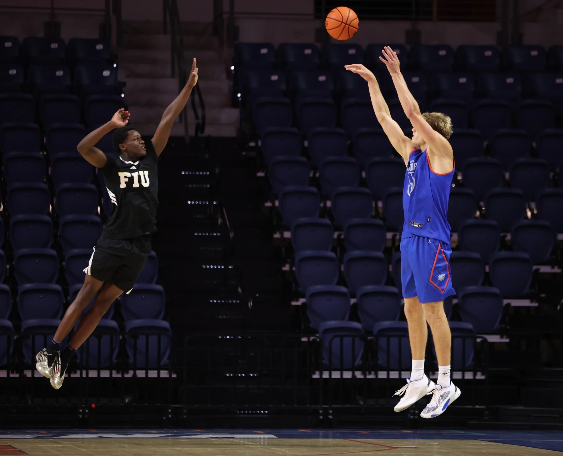 Thomas Haugh releases a jump shot as an FIU defender contests