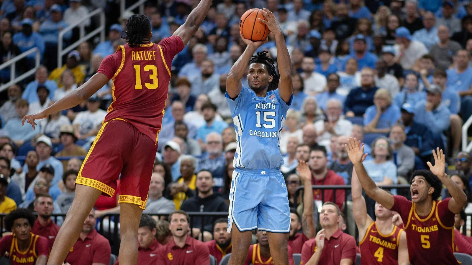 Jarin Stevenson in North Carolina blue number 15 shoots over a USC defender in red number 13
