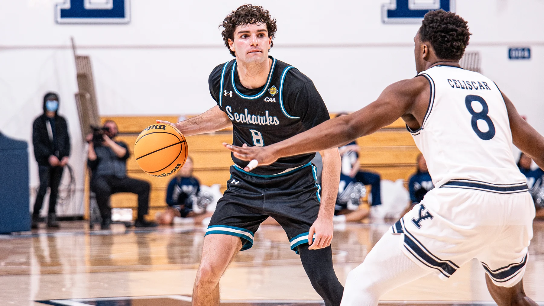 Christian May handles the ball against Yale's Isaac Celiscar during the March 2026 NIT game